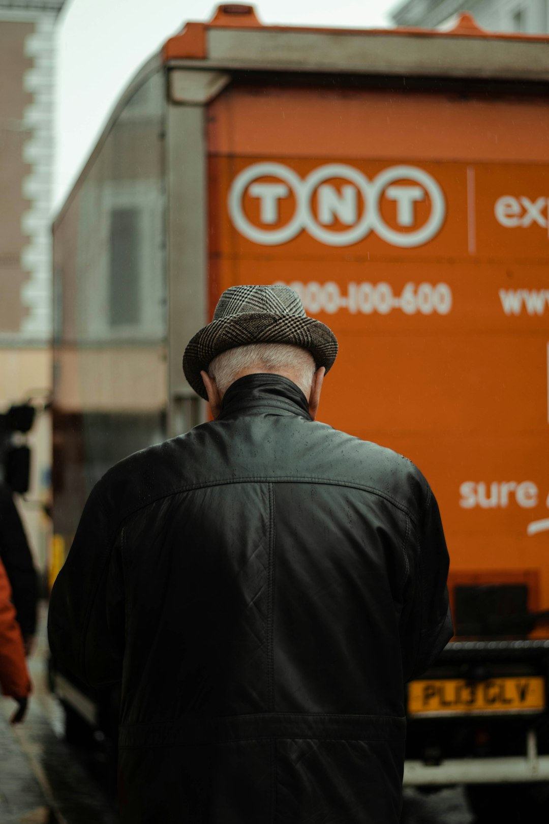 man in black leather jacket wearing brown fedora hat