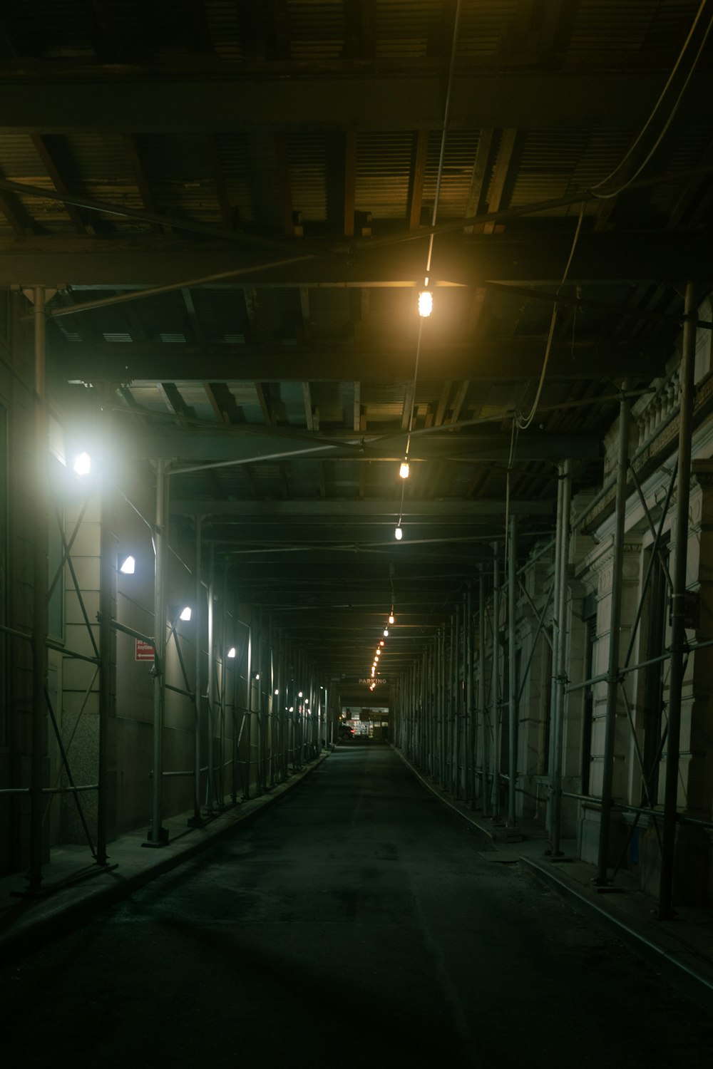 black metal framed tunnel with lights turned on during night time