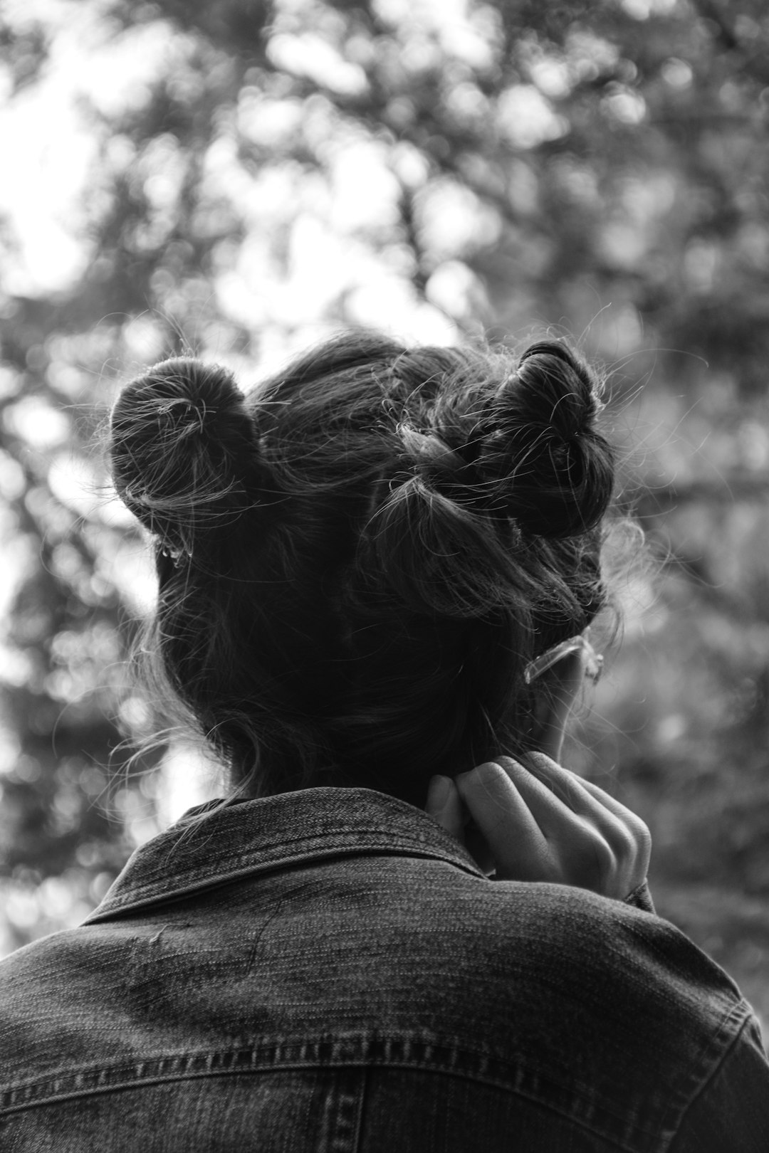 grayscale photo of woman covering her face with her hair