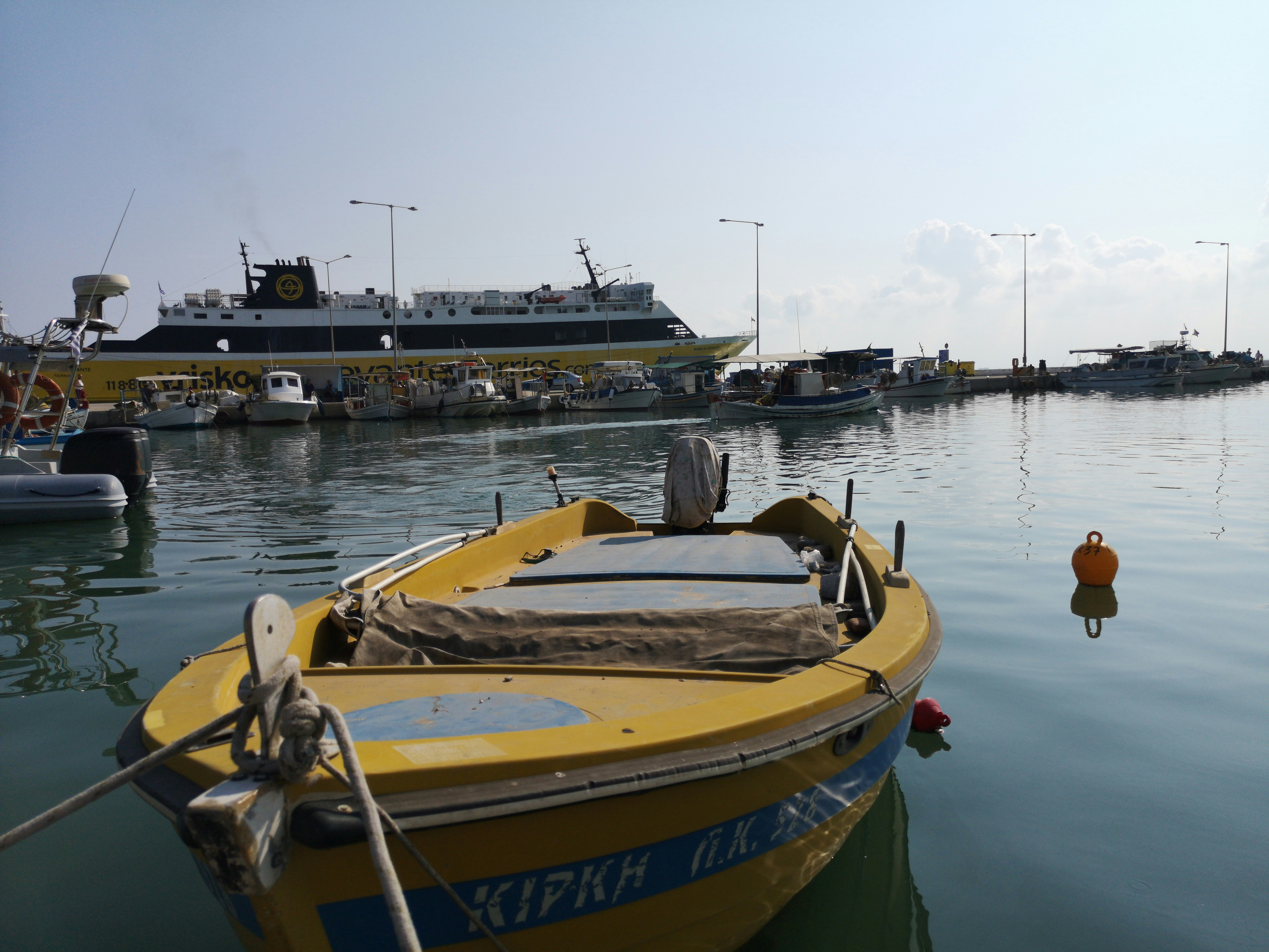 yellow and blue boat on dock during daytime