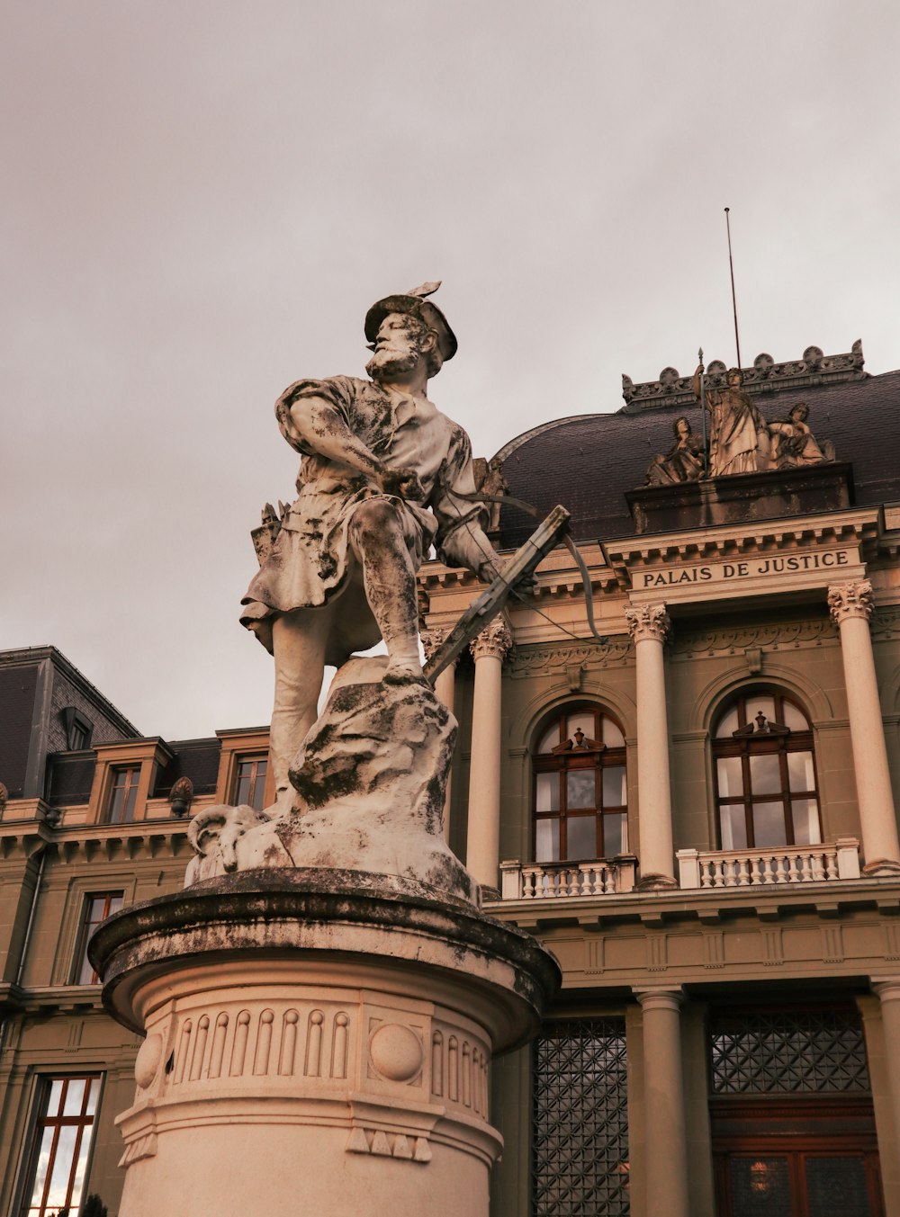 man riding horse statue near brown building