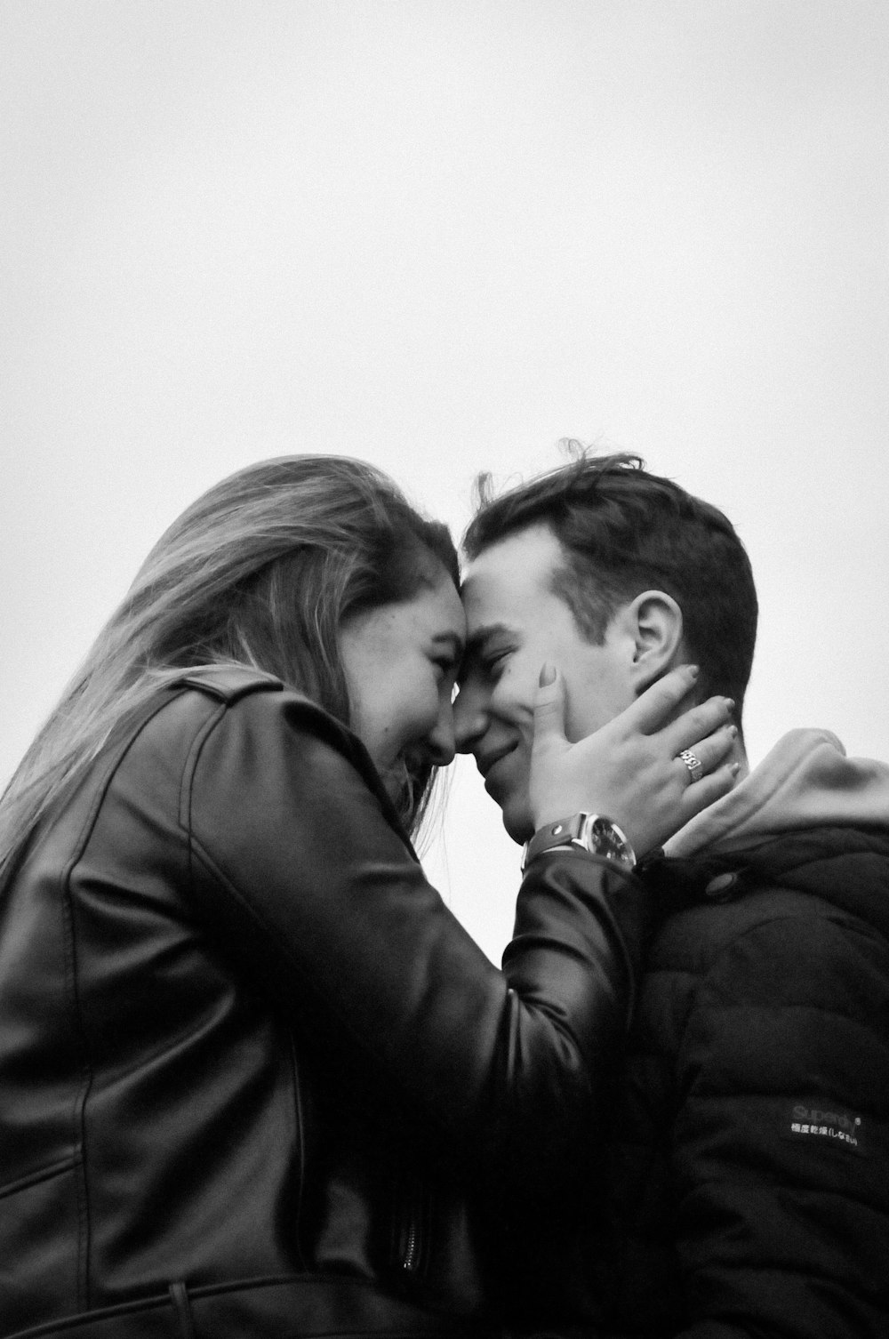 man kissing womans forehead