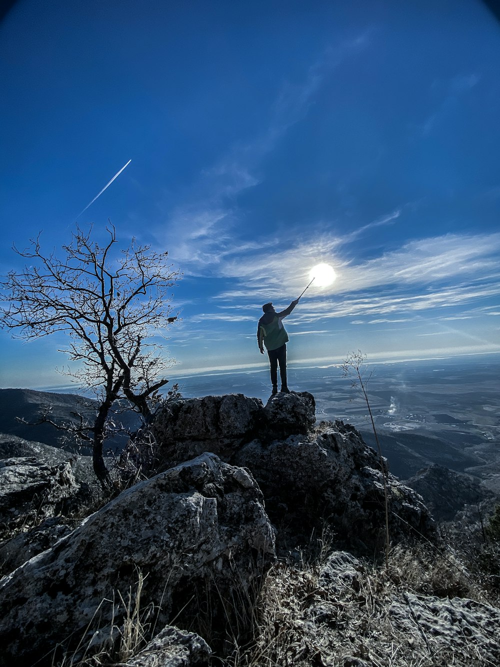 man standing on rock formation during daytime