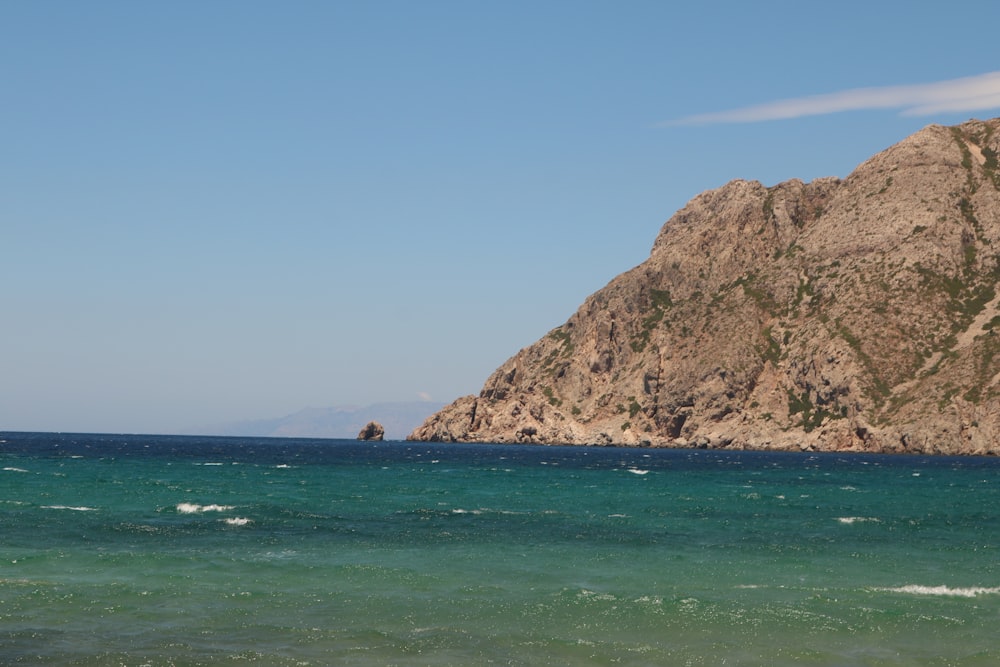 brown rock formation on sea during daytime