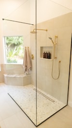white bathtub with shower curtain