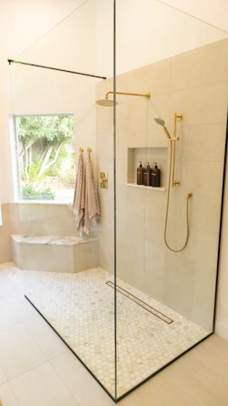 Marble shower floor installed with warm porcelain tile Mill Creek Community Remodel Bathroom