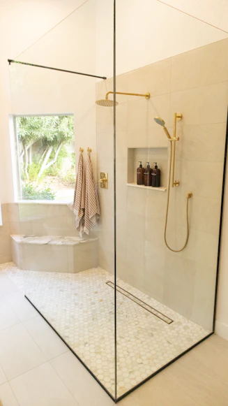 Marble shower floor installed with warm porcelain tile Mill Creek Community Remodel Bathroom