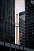 white and red tower near high rise building during daytime