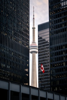 white and red tower near high rise building during daytime