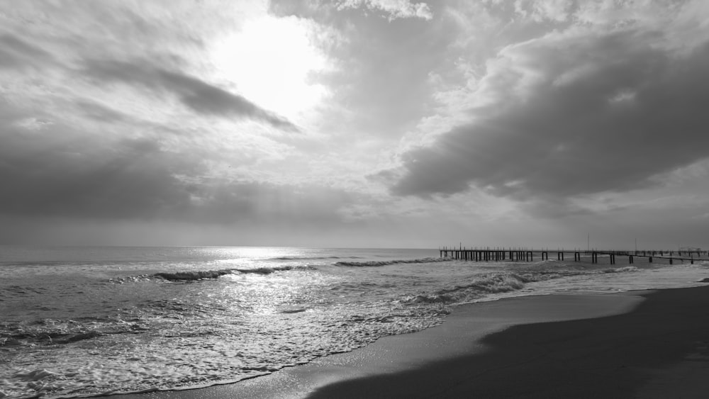 grayscale photo of sea waves crashing on shore