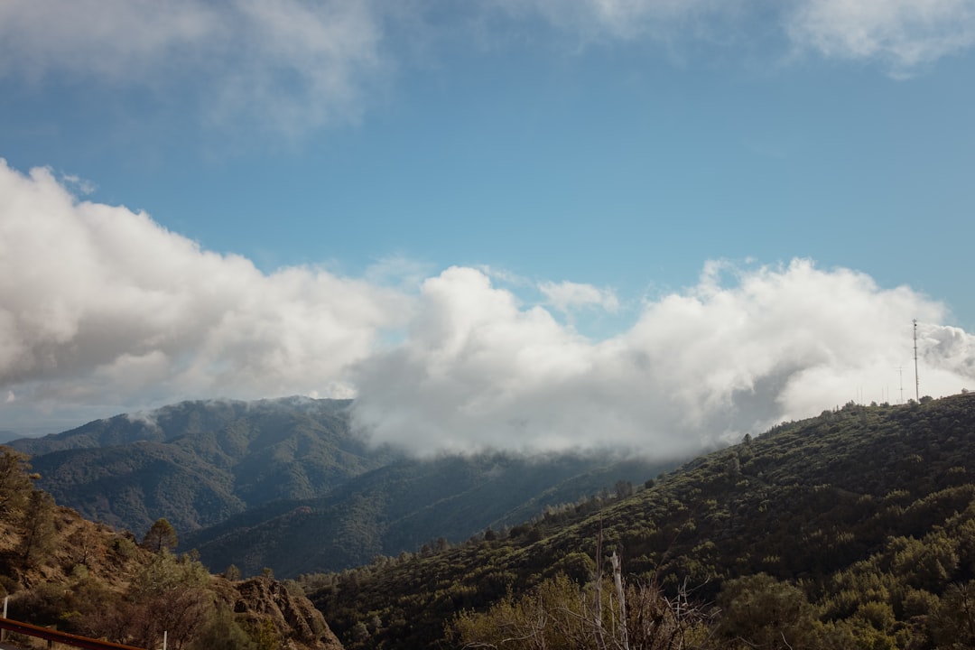 green and brown mountains under white clouds and blue sky during daytime