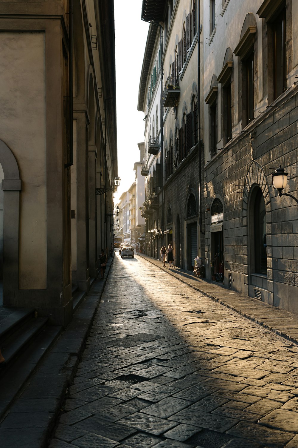 empty street between concrete buildings during daytime