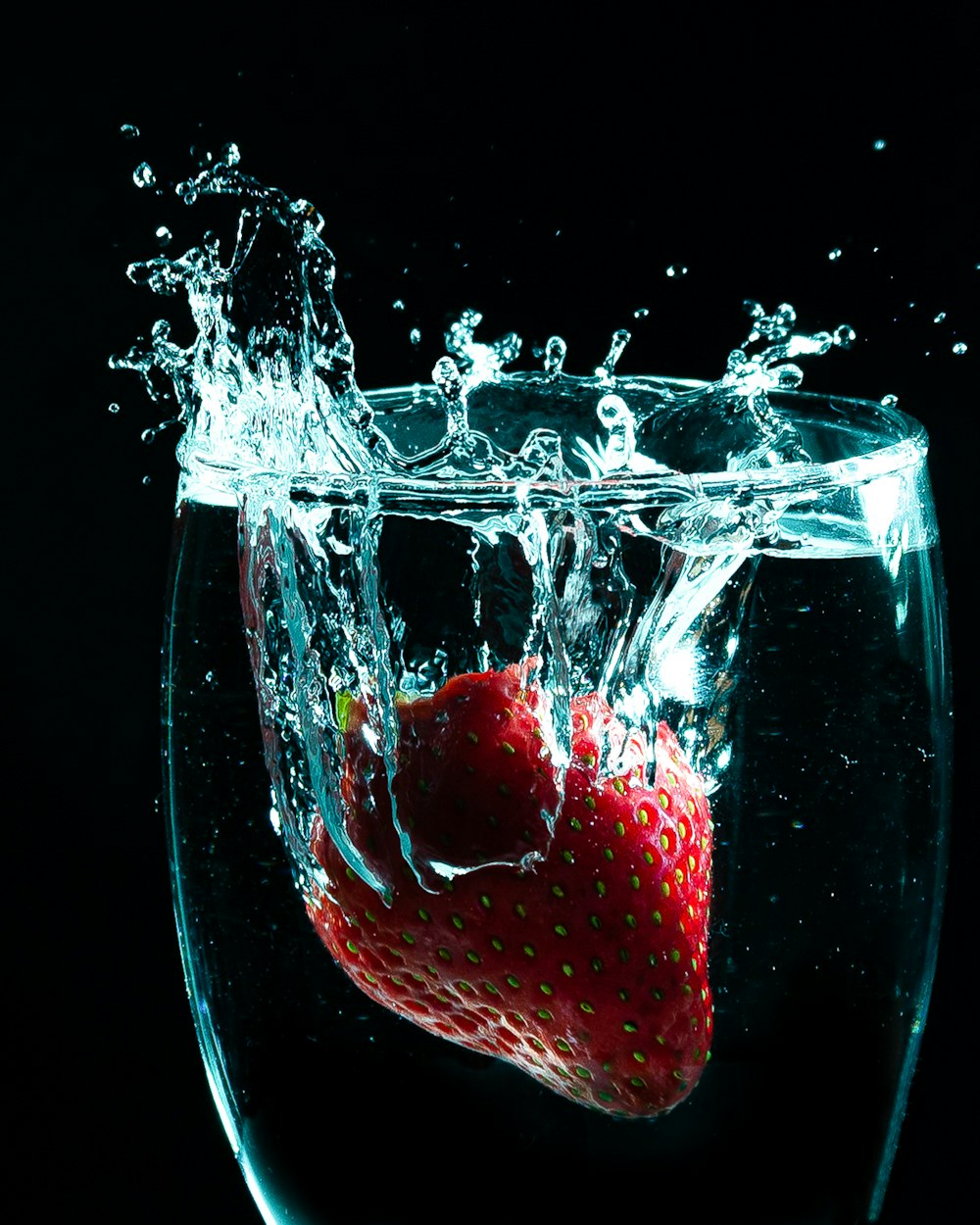 red strawberry in clear wine glass