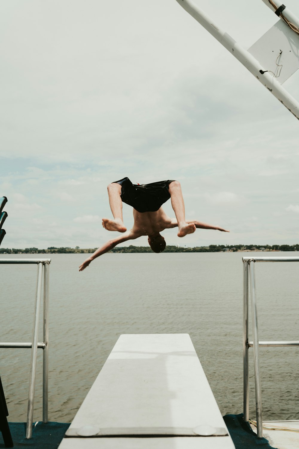 man in black shorts jumping on water