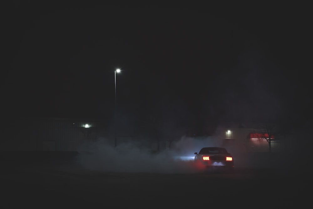 red car on road during night time