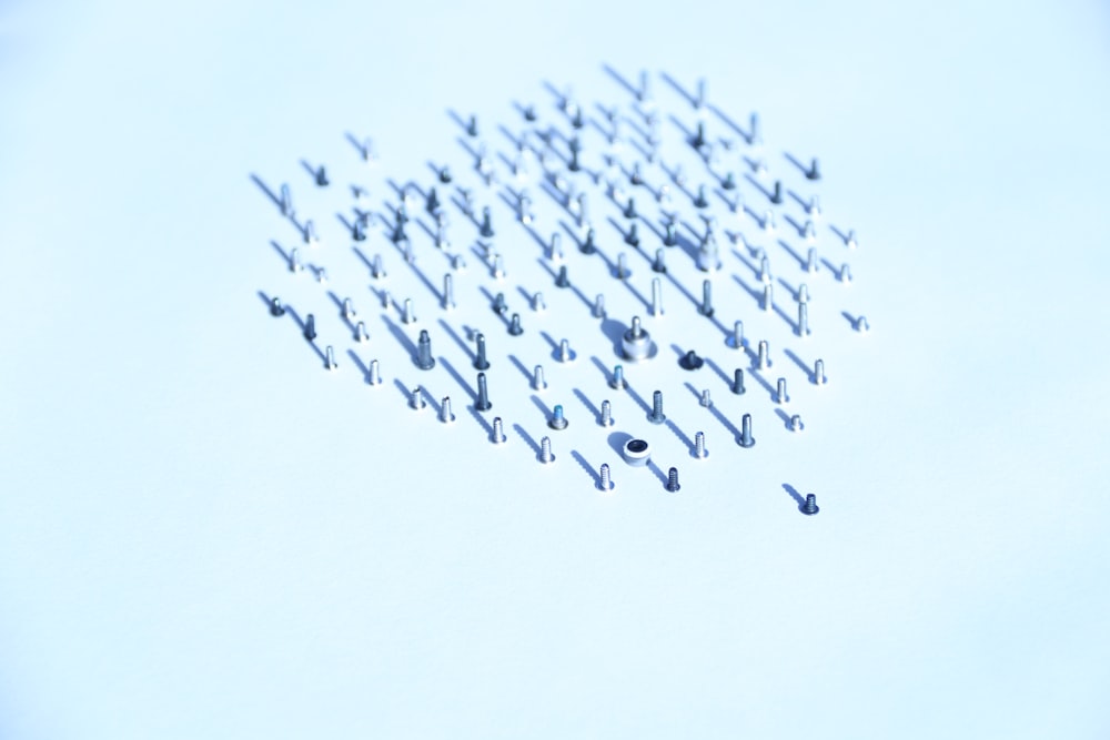 flock of birds flying under white sky during daytime