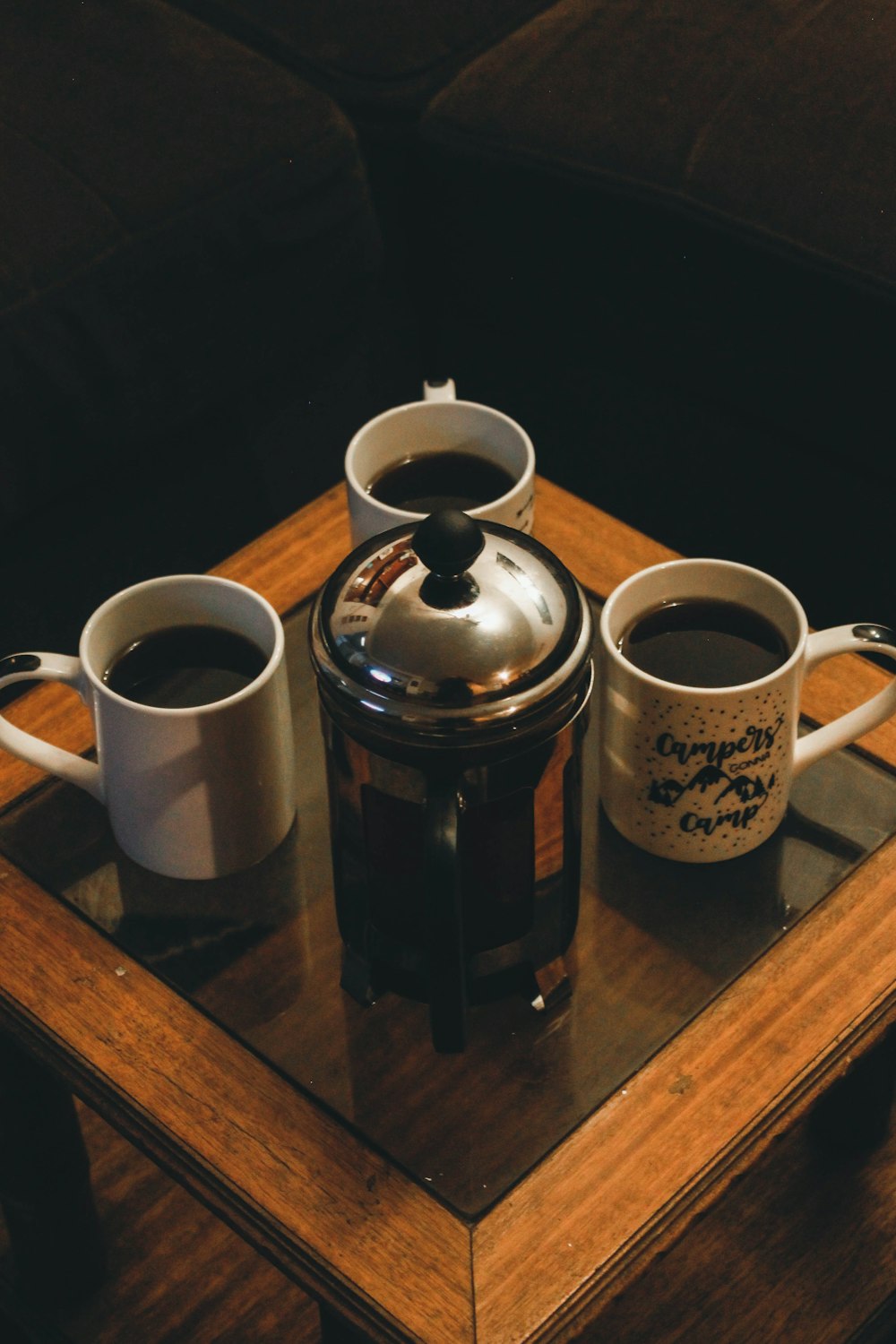 white ceramic mug beside black and white ceramic mug