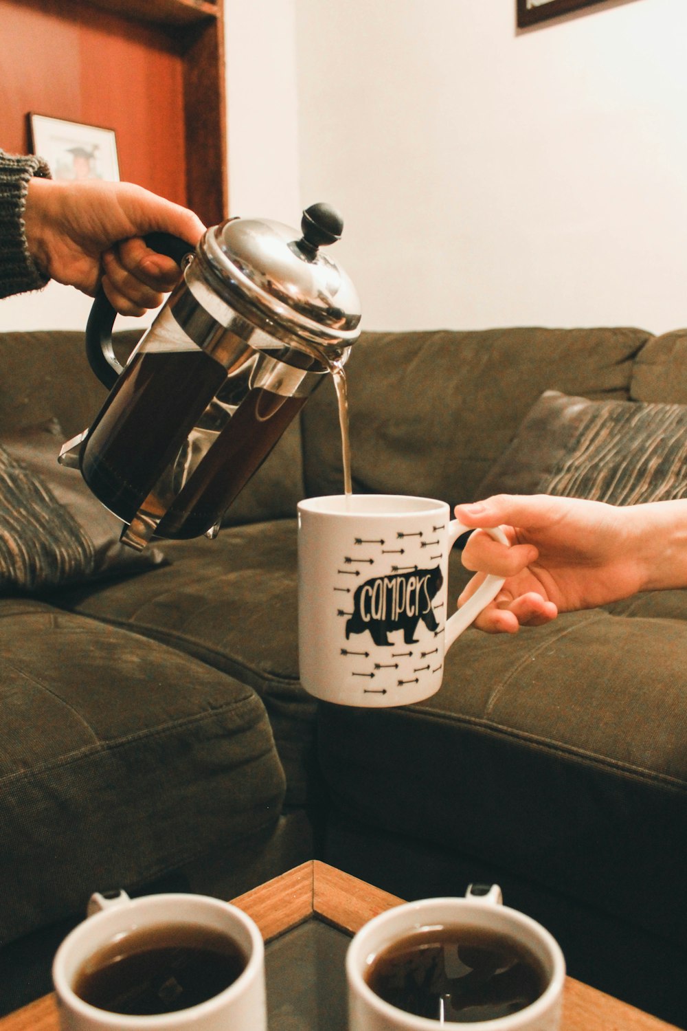 person holding white ceramic mug