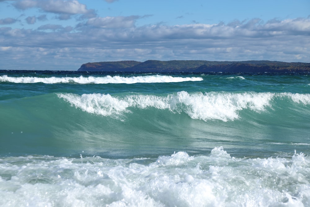 ocean waves under cloudy sky during daytime