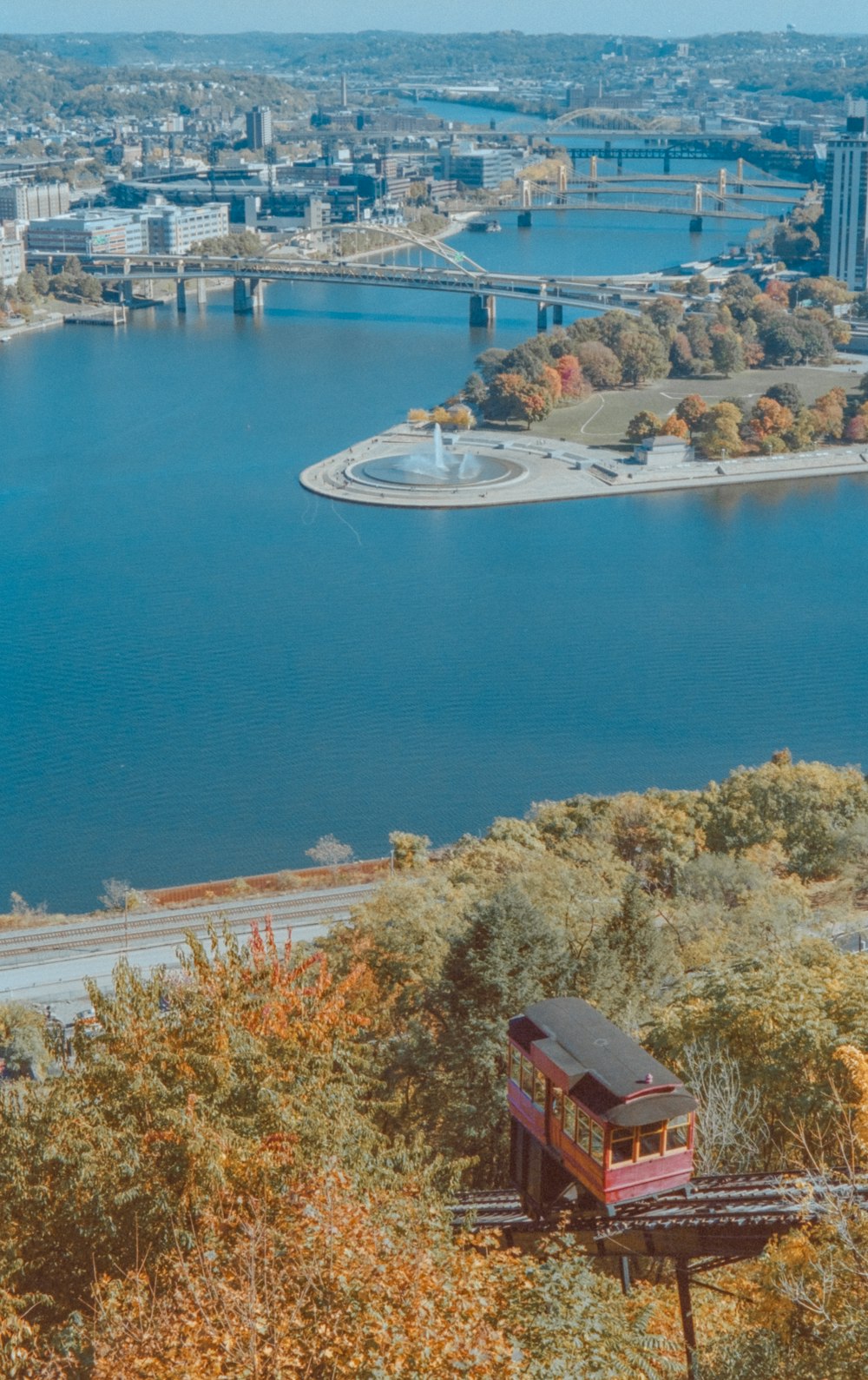 white and red building near body of water during daytime