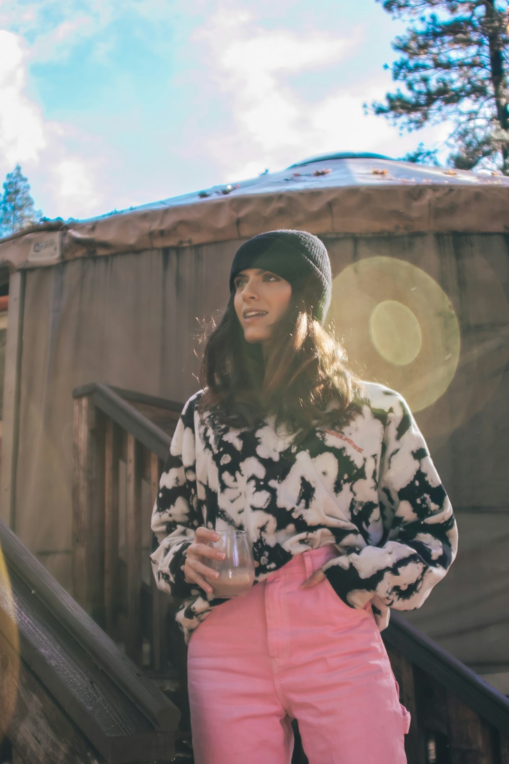 woman in black and white floral long sleeve shirt and black knit cap