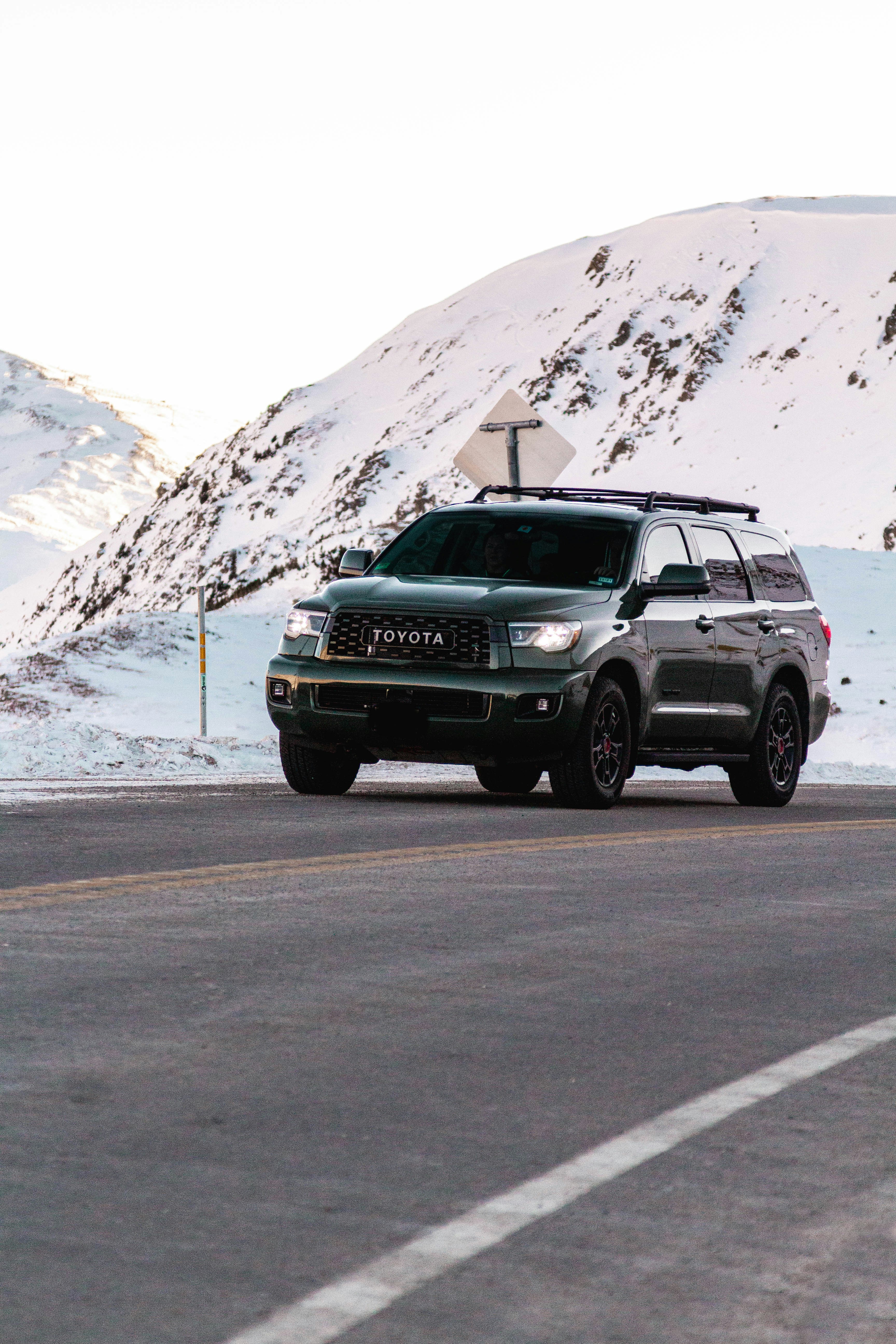 gray suv on road near snow covered mountain during daytime