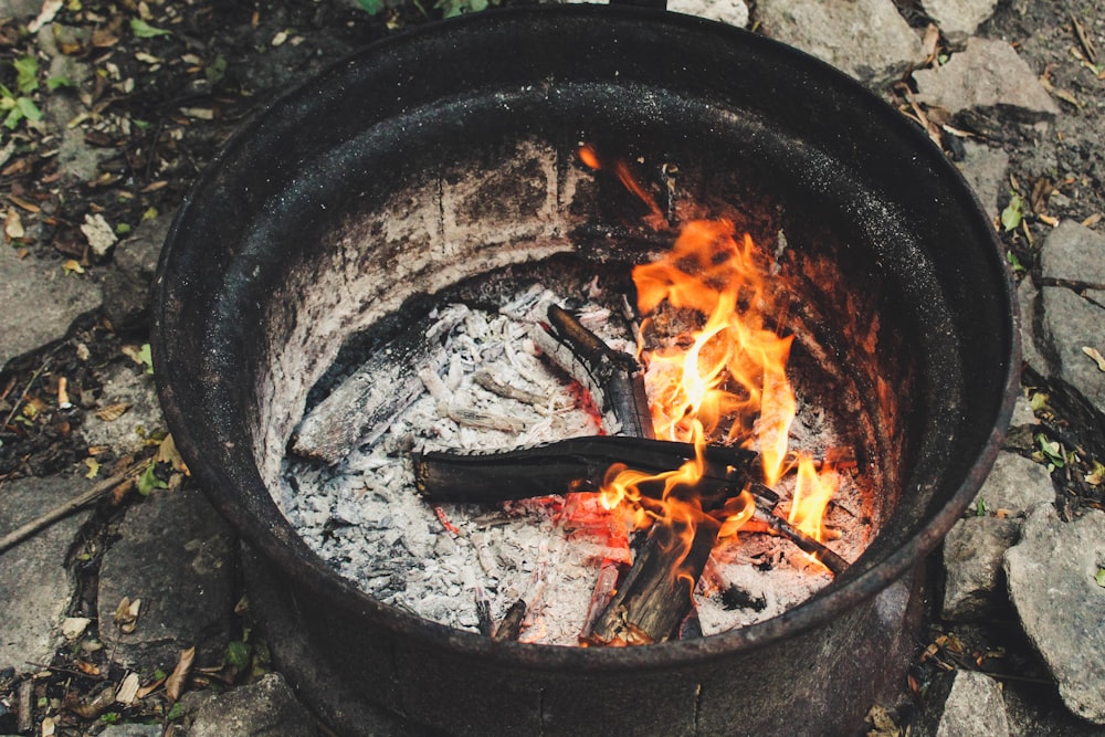 burning wood in black round pot