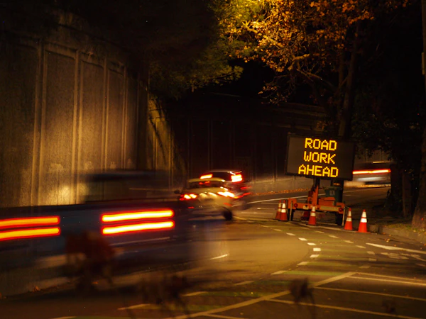 Road work ahead sign at night