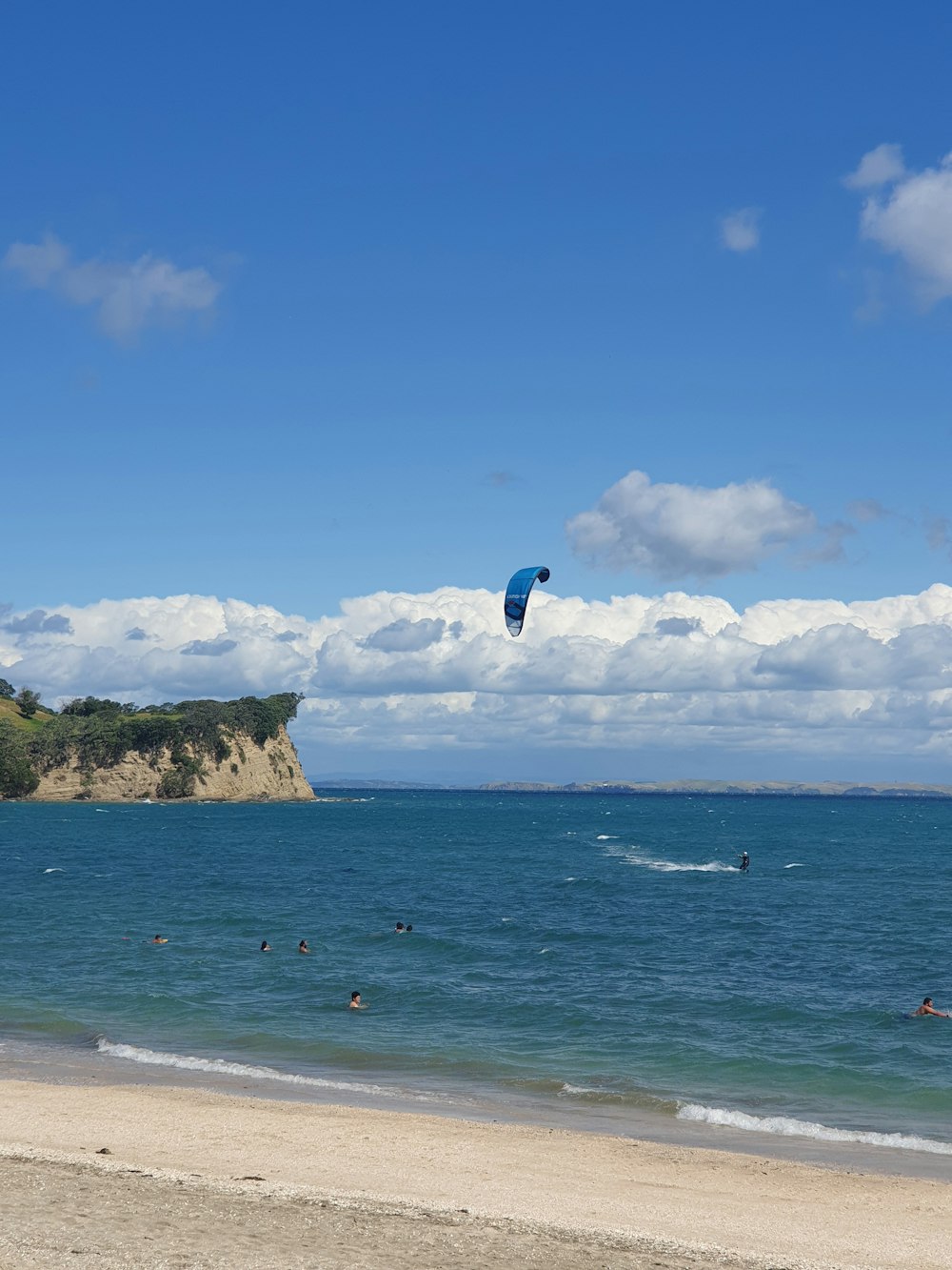 person in blue jacket and blue denim jeans jumping on sea during daytime