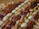 Close-up of a handful of fresh pecan nuts on a rustic wooden table.
