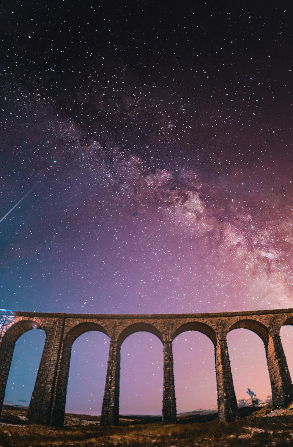 brown concrete bridge under purple sky