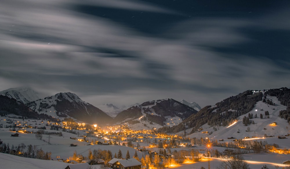 snow covered mountains under cloudy sky during daytime