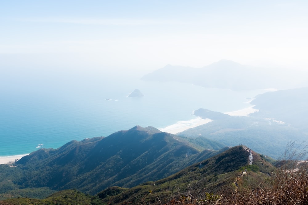 green mountains near body of water during daytime