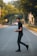 man in black shirt and black pants walking on road during daytime