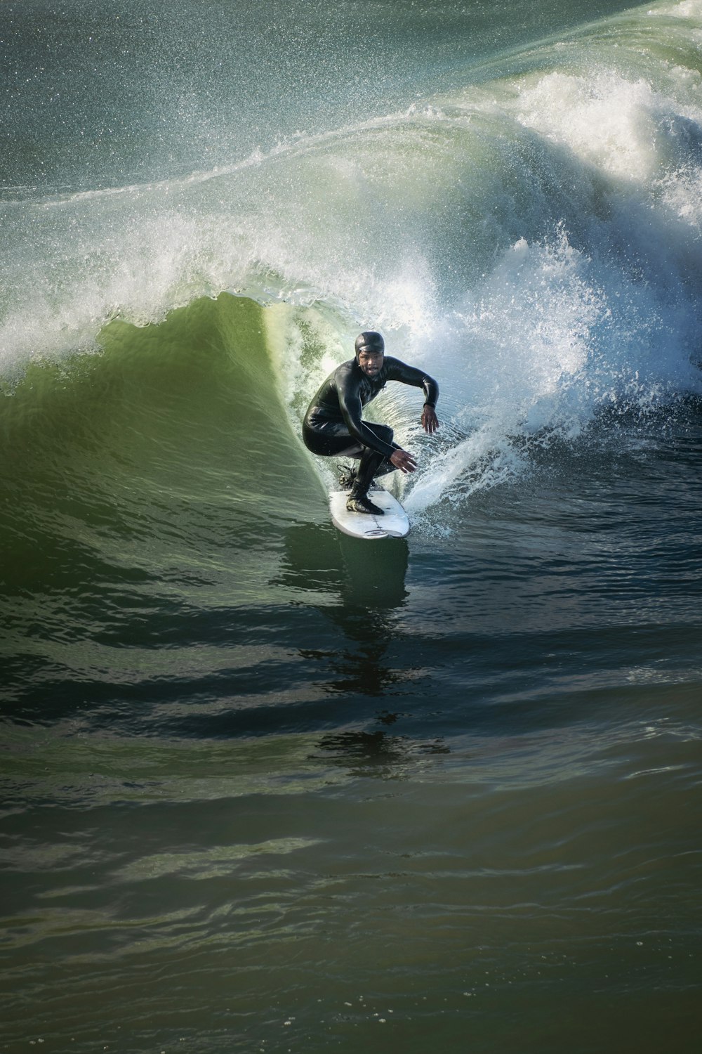 man surfing on sea waves during daytime