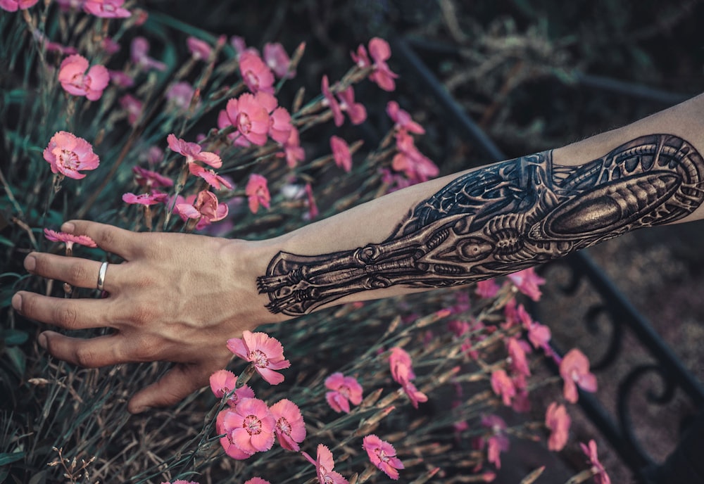 black and white floral tattoo on persons hand