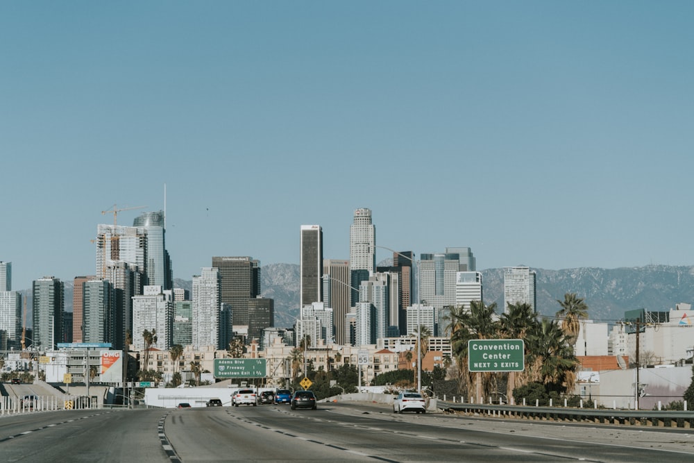 cars on road near city buildings during daytime