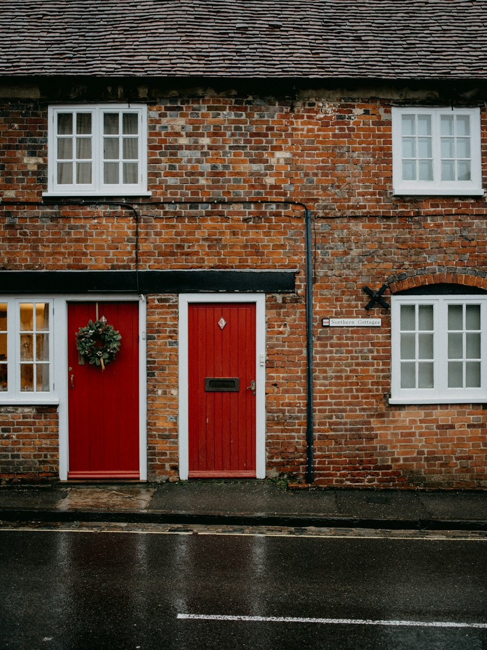 red wooden door on brown brick building