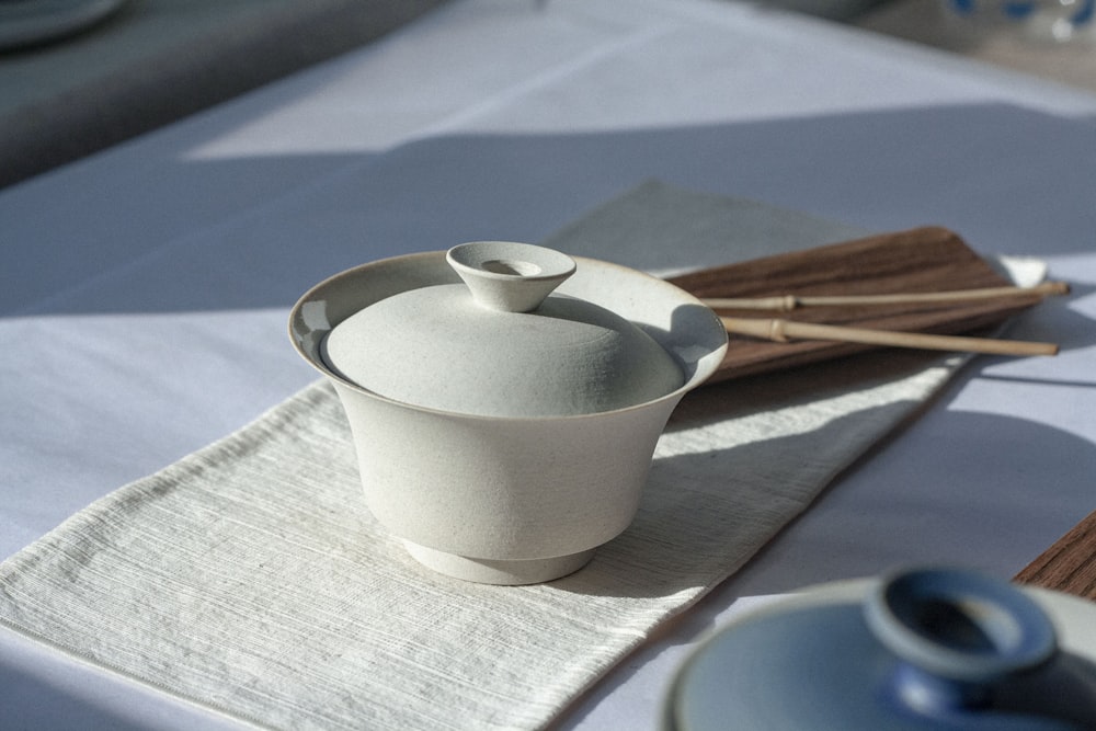 white ceramic cup on white tissue paper