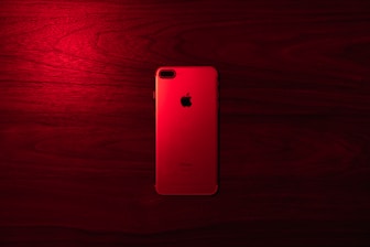 gold iphone 6 on red wooden table