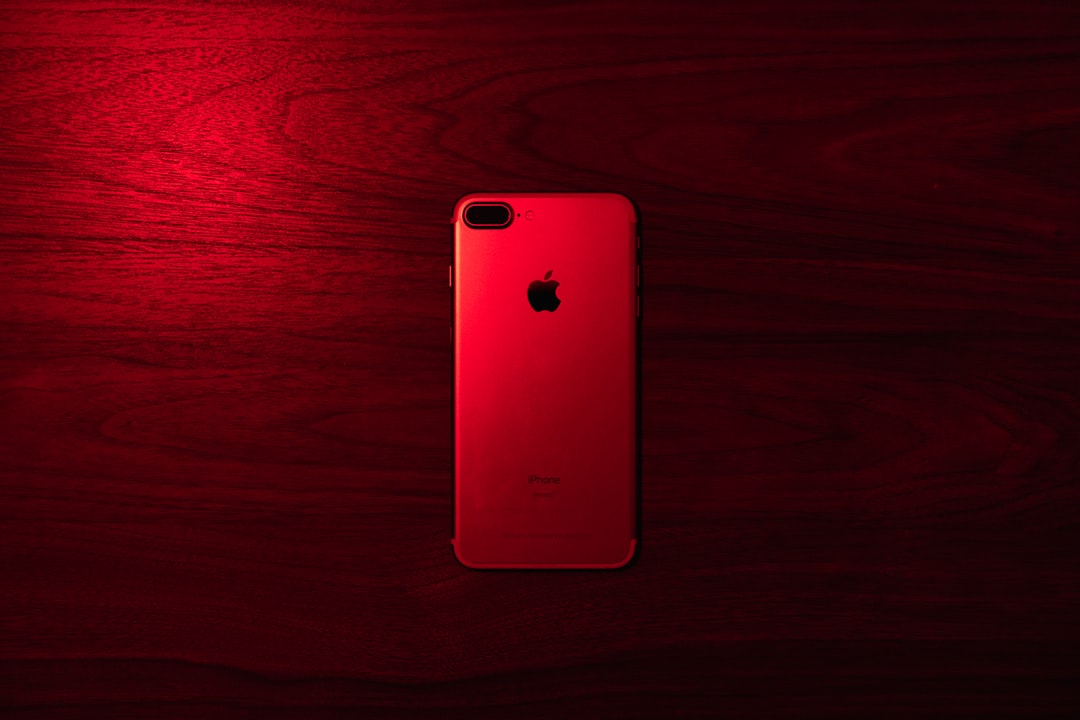 gold iphone 6 on red wooden table