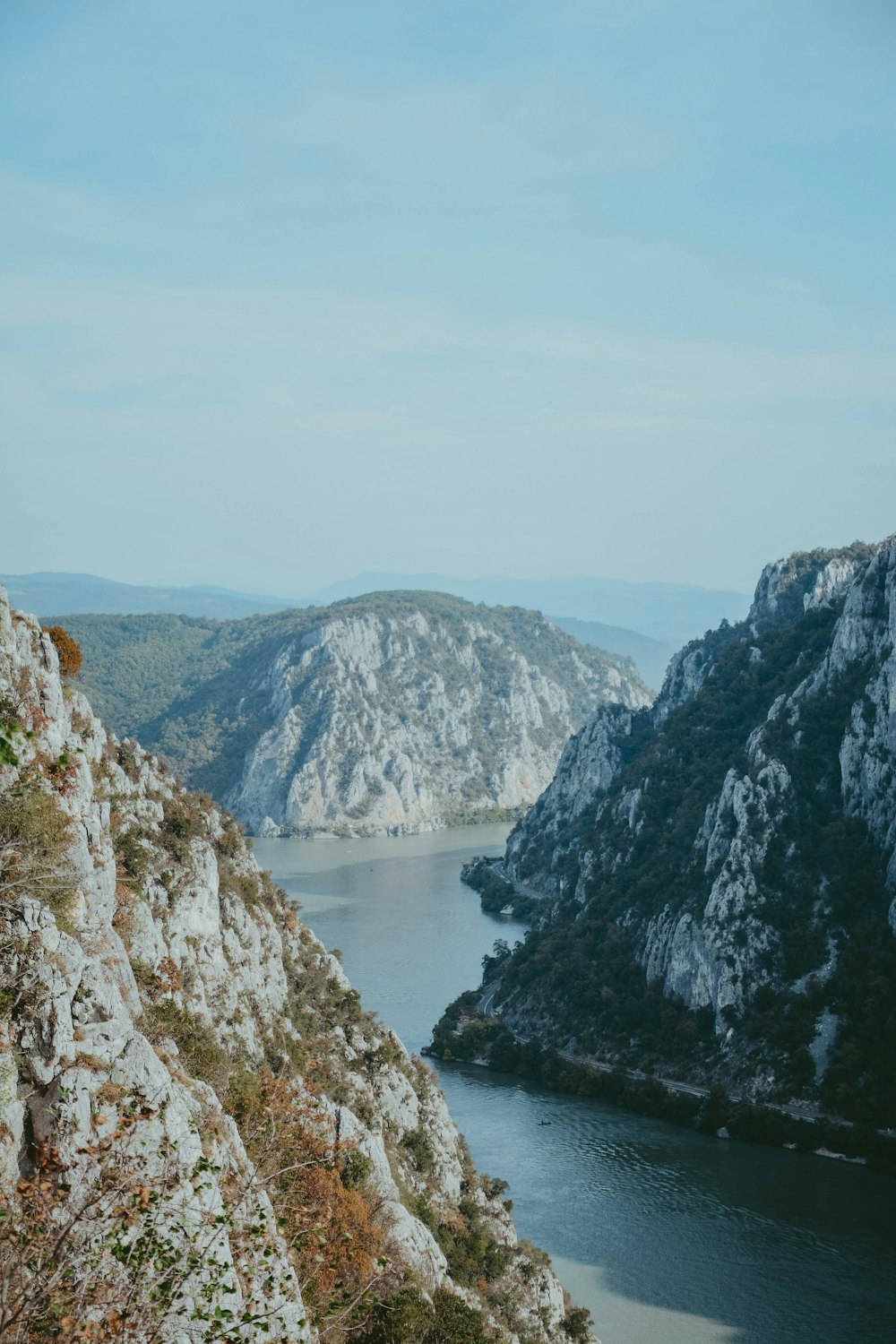 body of water between mountains during daytime