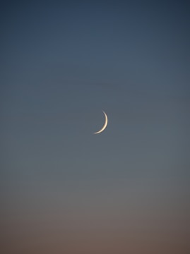 white crescent moon in the sky