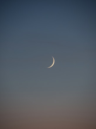 white crescent moon in the sky