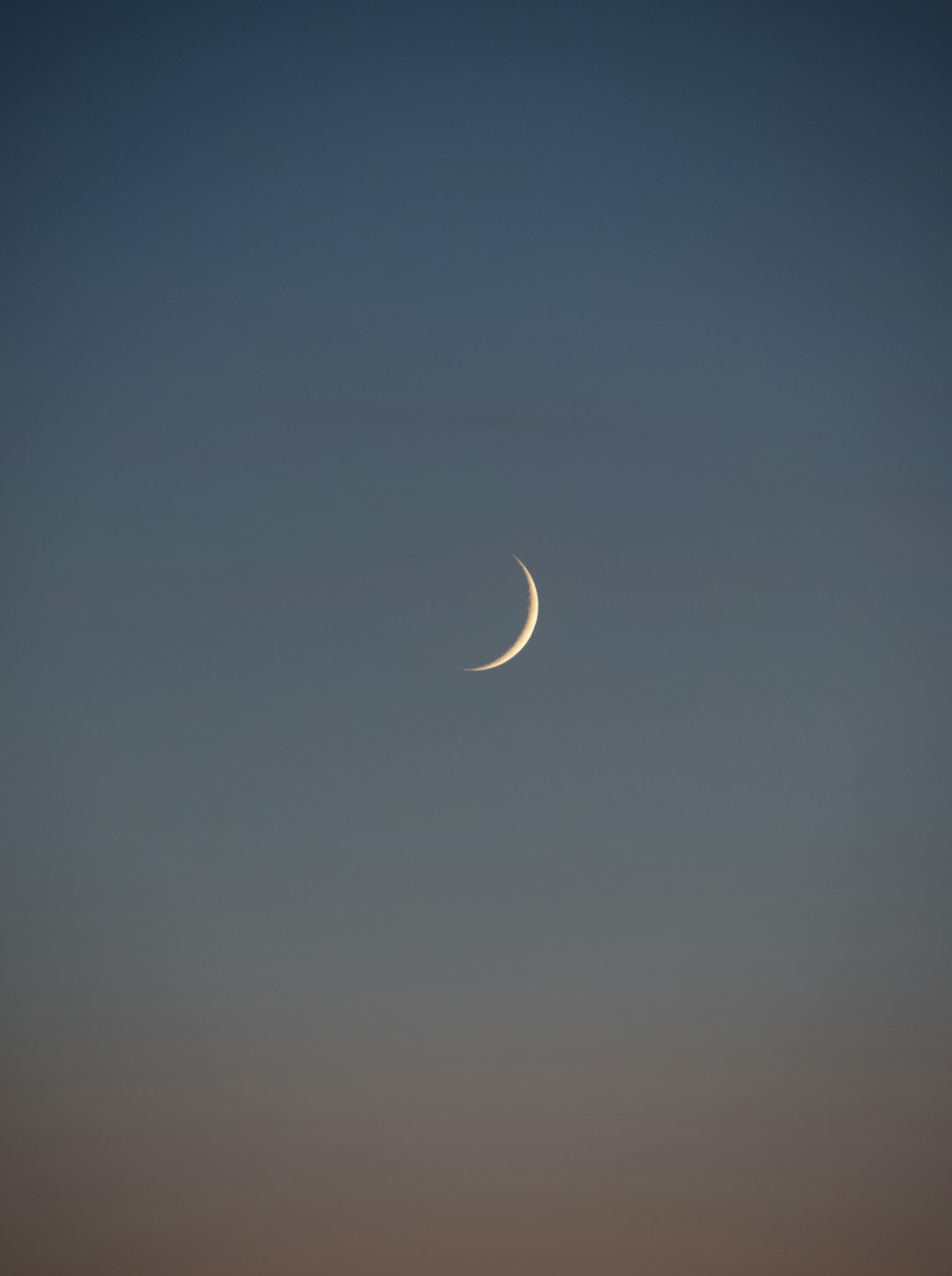 white crescent moon in the sky