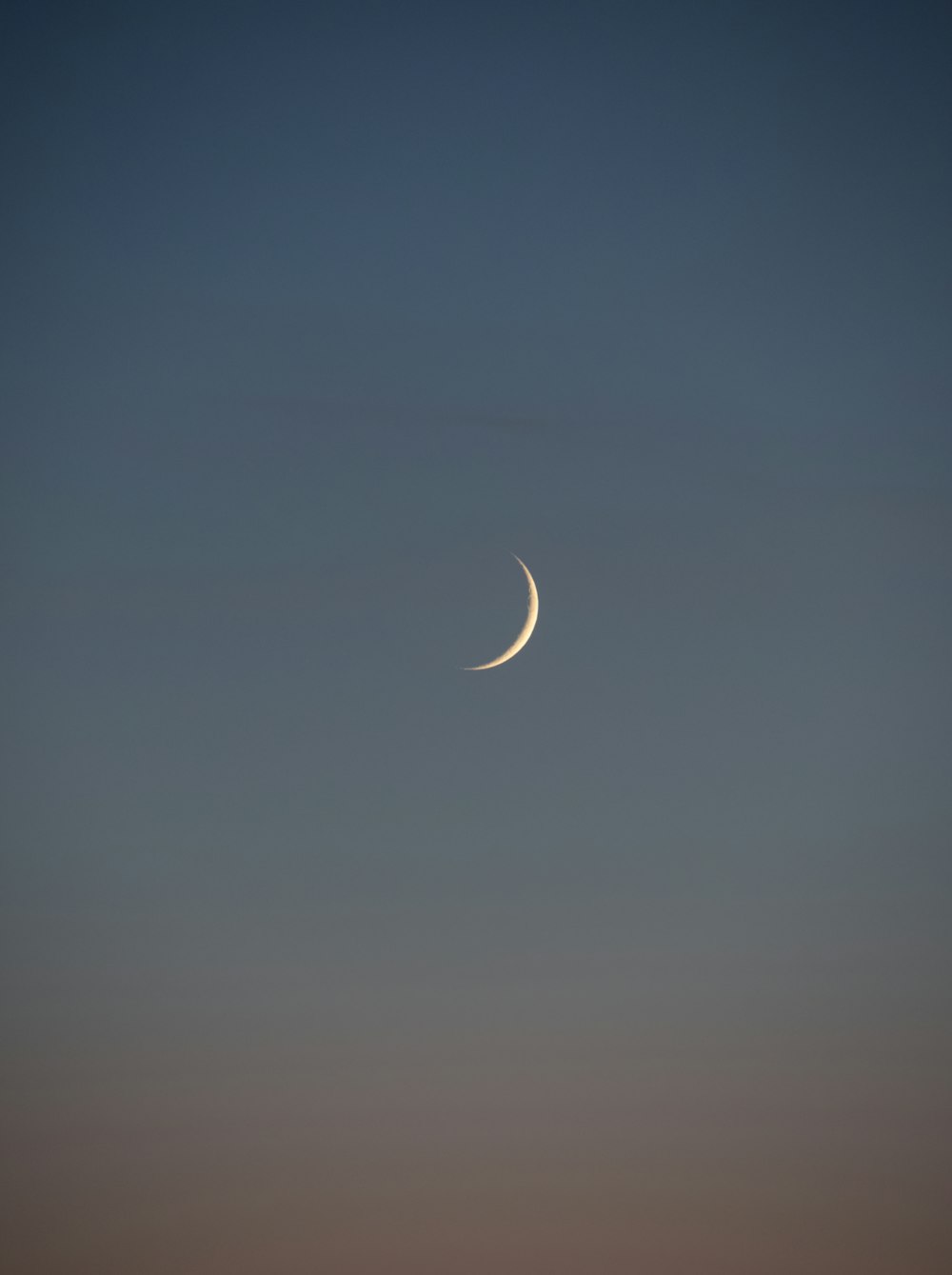 white crescent moon in the sky