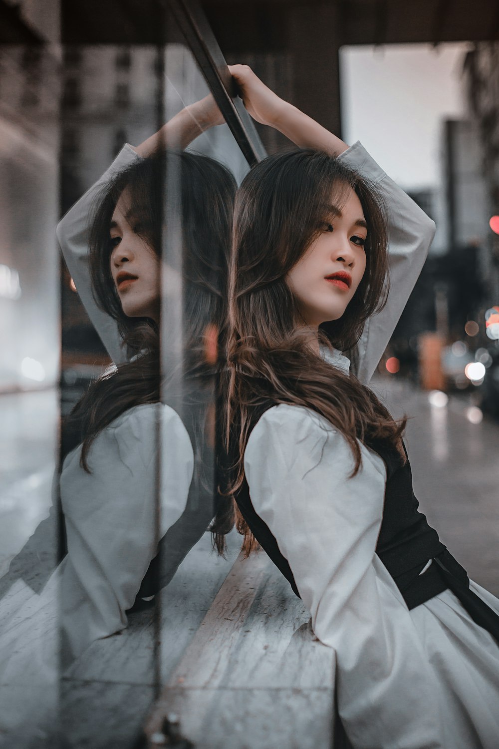 woman in white long sleeve shirt covering her face with umbrella