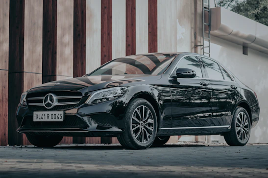 black porsche 911 parked in front of brown wooden wall