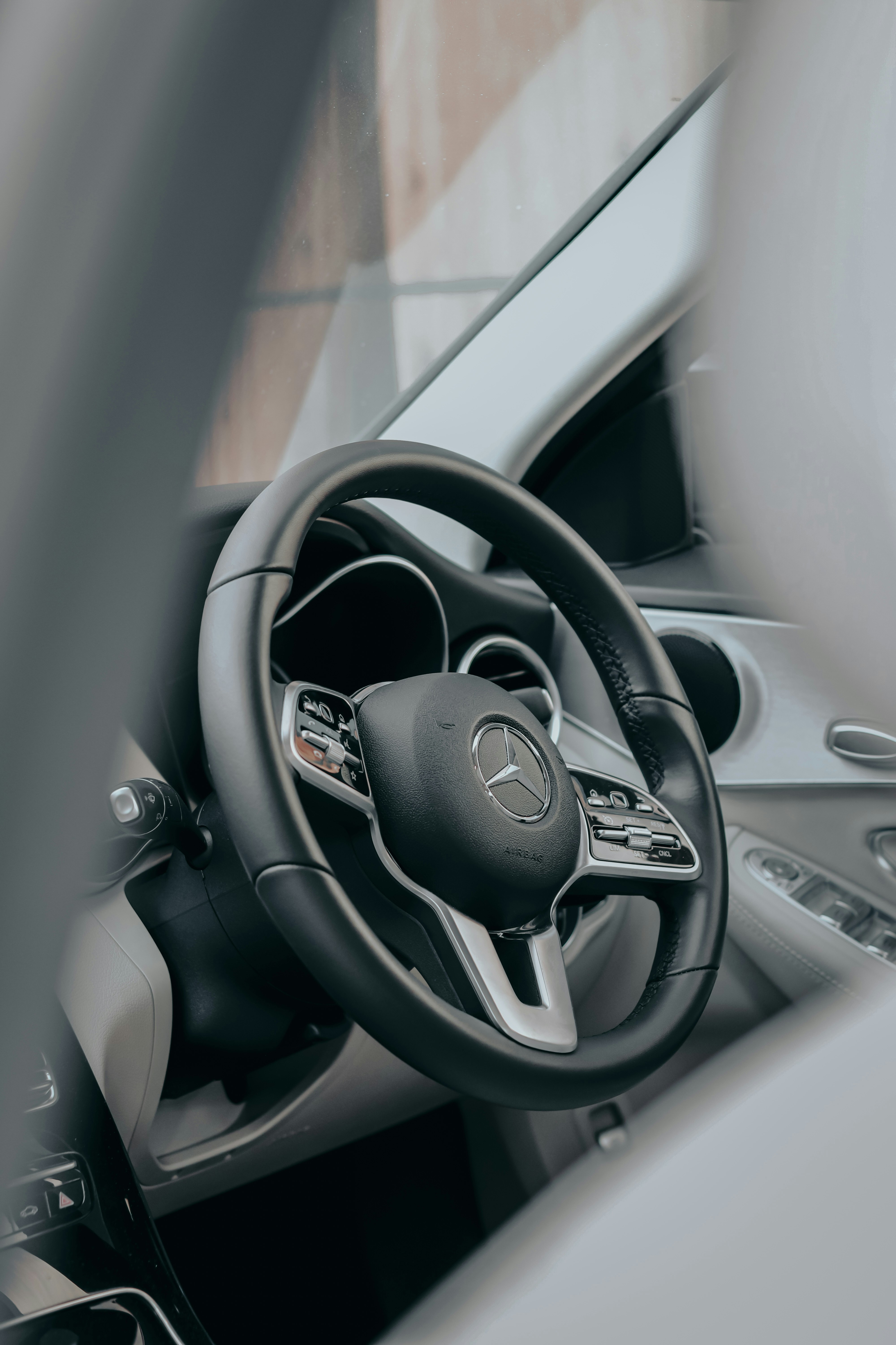 black and silver mercedes benz steering wheel