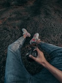 person in blue denim jeans and white and orange sneakers